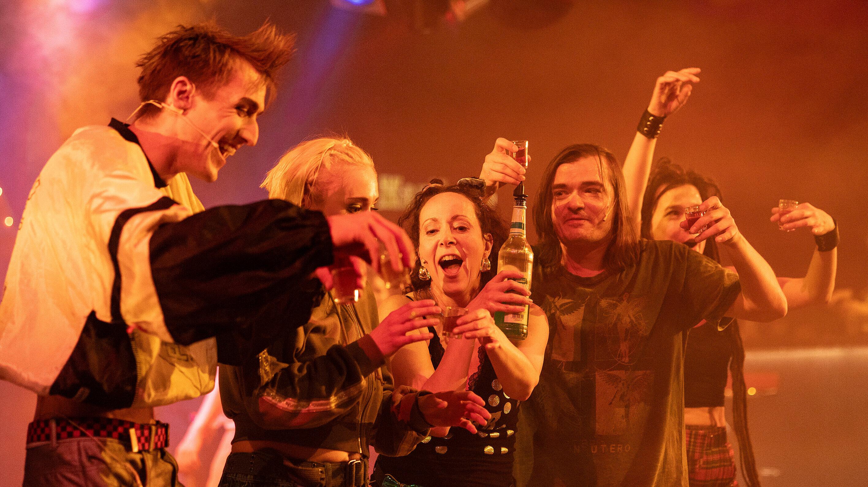Eine Gruppe von Schaustellern trinken zusammen einen Shot Alkohol. © Theater Altenburg