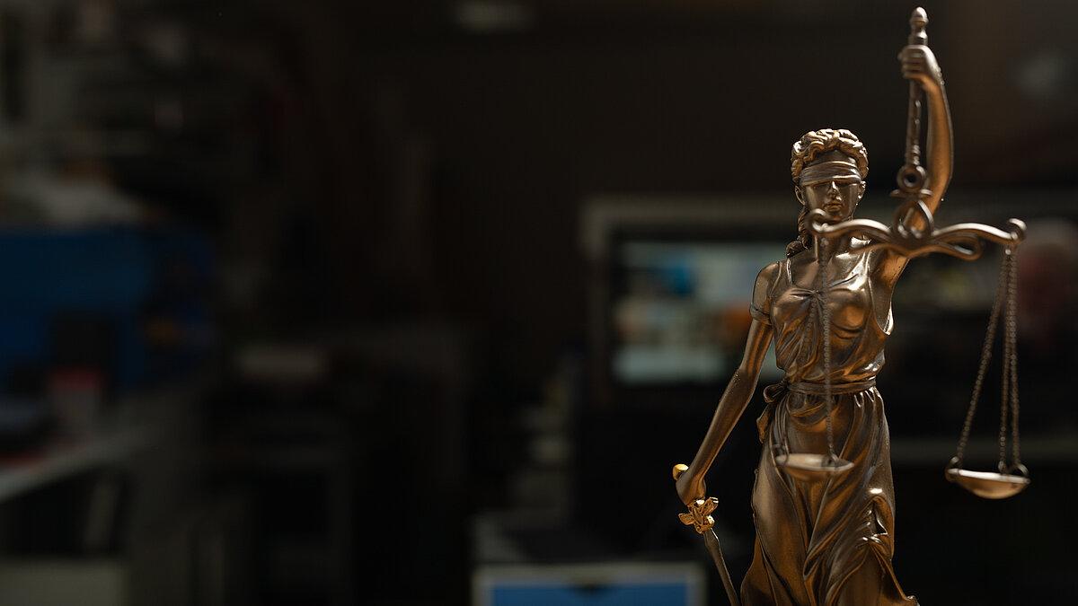 Bild von einer vergoldeten Figur, mit einer Waage in der Hand
