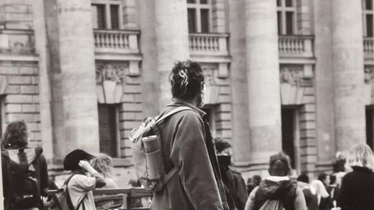 Abschlussarbeit der Auszubildenden der SBBS Wirtschaft und Verwaltung Gera, zu sehen ist eine Demonstration, die Person in der Mitte ist von hinten zu sehen und trägt ein Schild mit der Aufschrift: 'SAY THEIR NAMES RACISM KILLS', das Bild ist schwarz/weiß. © SBBS Wirtschaft und Verwaltung Gera